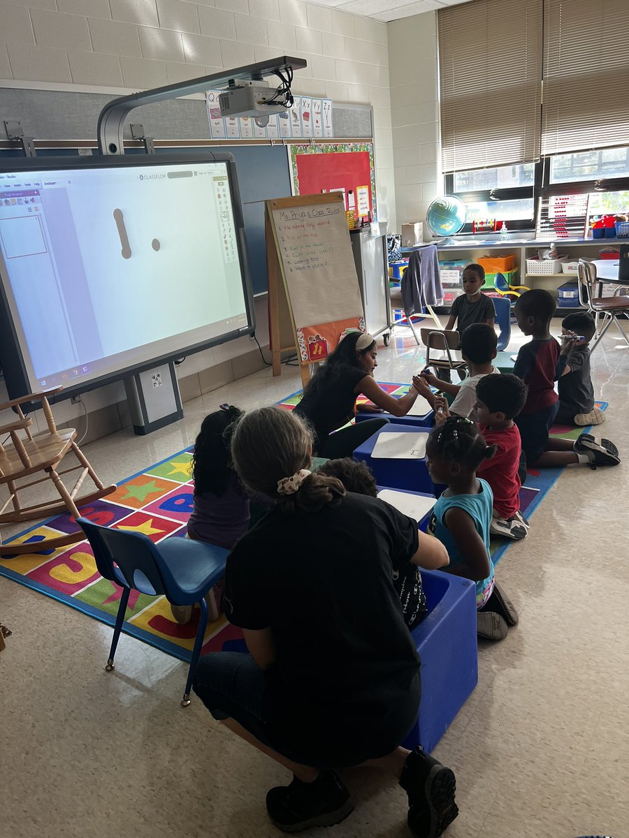 Students in Ms. Pai’s class working on number formation 🧡💙