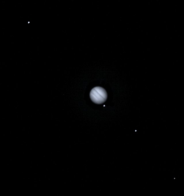 A cropped composite of a DRACO image centered on Jupiter taken during one of SMART Nav’s tests. When the image was taken, DART was approximately 16 million miles (26 million km) from Earth, with Jupiter approximately 435 million miles (700 million km) away from the spacecraft. Jupiter is in the center of the image while its four moons appear as white dots in a diagonal line with Jupiter 
