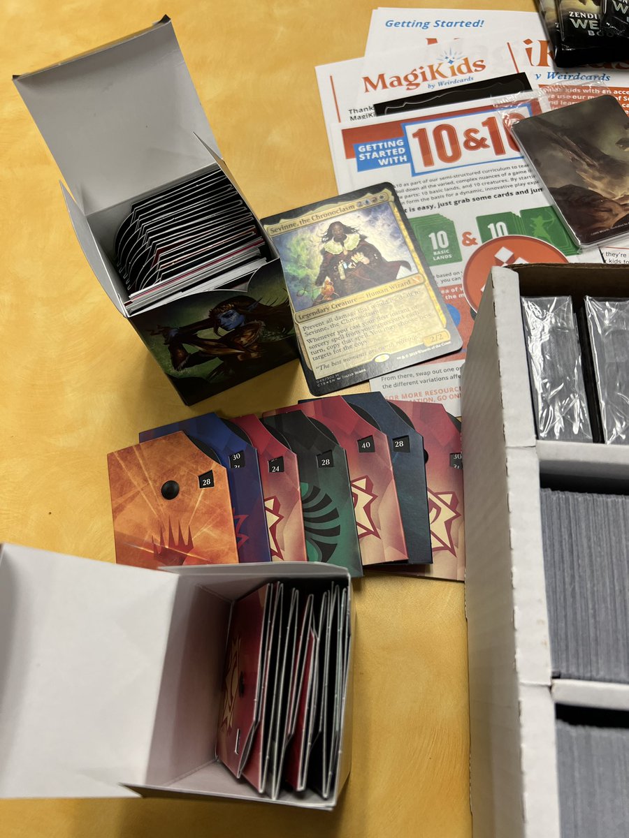 comics_teacher's tweet photo. The Oak Lawn High Game Club’s @magikidsMTG kit came today, and it is awesome!

Our students, new to the game, have more resources now, and with the game as expensive as it is…it’s MUCH appreciated. 

Go check them out and consider donating! https://t.co/iO22vkZLe5
