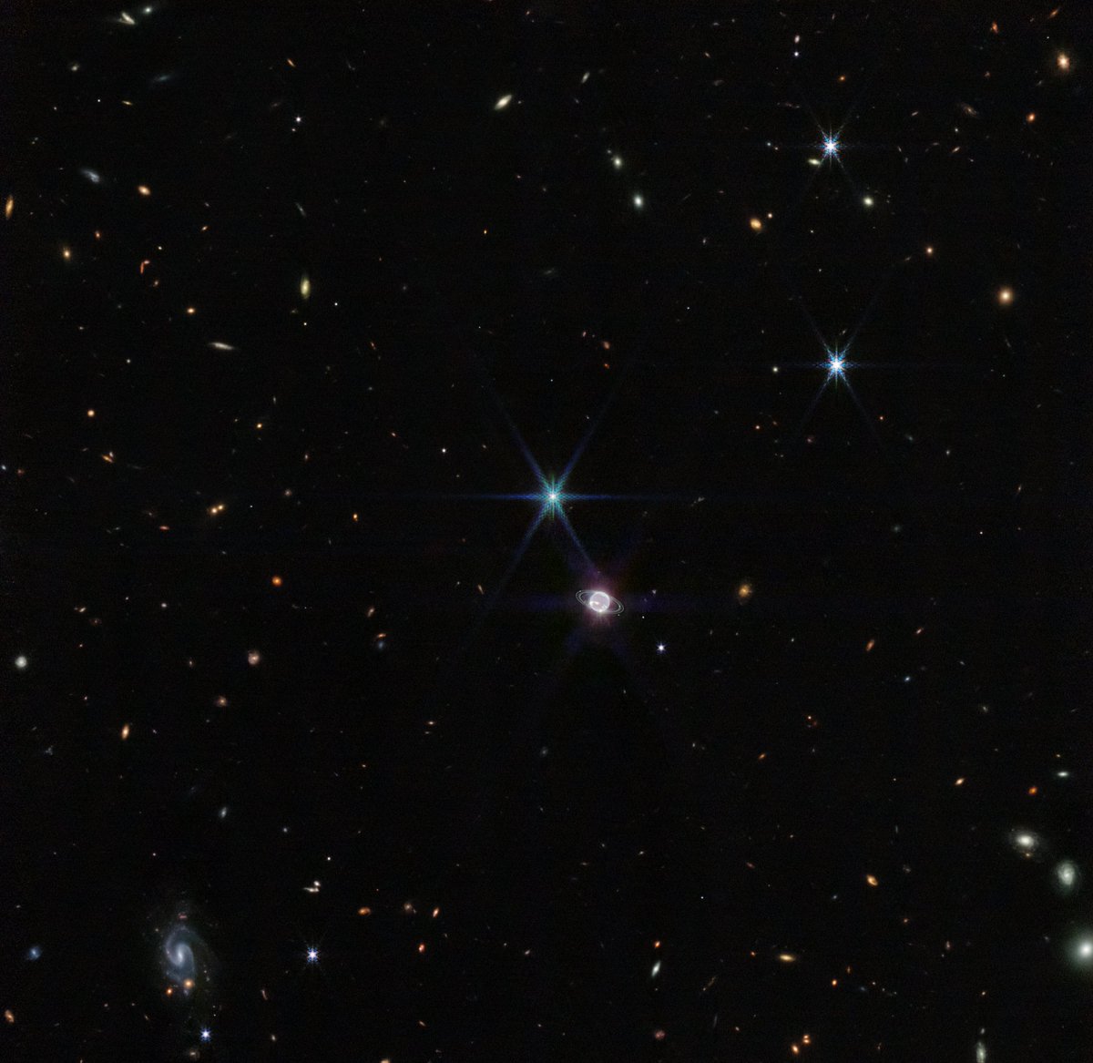 NASAExoplanets's tweet photo. Enhance!
@NASAWebb turned its infrared eye on Neptune and got the clearest images in decades of the ice giant's rings. The closeup is stunning, but so is the far-away view, showing our solar system's most distant planet and moons with galaxies far beyond. https://t.co/cGc1cpzc1V https://t.co/9SYR4NhL4R