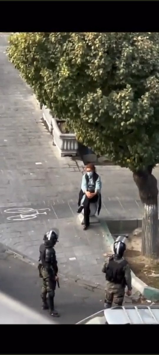 This picture and this brave woman will remain in the history. Being silent, she is sitting without Hijab right in front of the special forces.
Be the voice of Iranian people. The internet is shut down by the government.
#MahsaAmini 
#MahsaAminii 
#مهسا_امینی 
#IranProtests2022