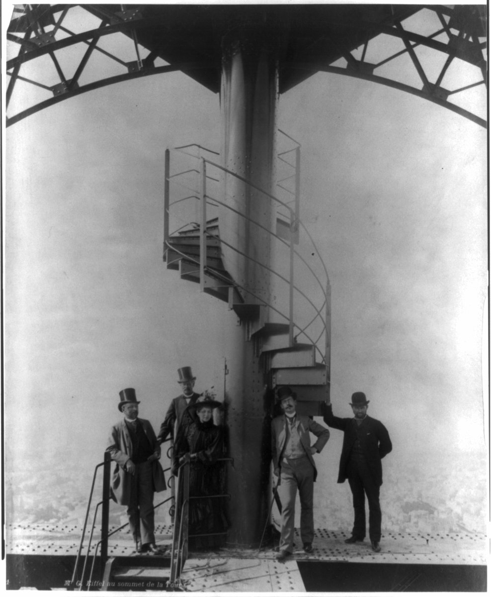 PhotosOfOld's tweet photo. Engineer Gustave Eiffel (right) and four others pose for a photo at the summit of the newly constructed #EiffelTower, circa 1888. #Paris #France #history #architecture #TopHats #1800s https://t.co/fBUthnag1S