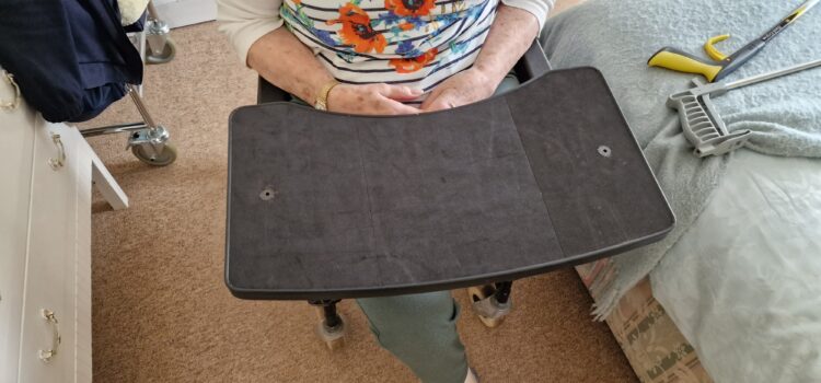 Sylvia needed a tray fitted to her wheelchair which was both secure enough for her to carry items, but also easy for her to remove and place back on as she lives alone.

She can now move around her property with the table in place, remove it and place it back on independently.