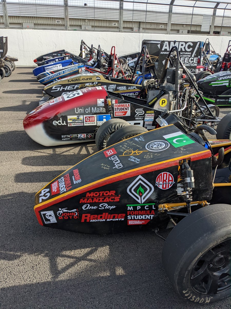 FormulaStudent's tweet photo. Slightly different #thorowbackthursday of all the #FS2022 cars lined up for the offical event photo @UHRacing @UGRacing_fsae @UoM_Motorsports @Cardiff_Racing @SDUengineering @teamauj @TeamSFR @UWE_FS @SHU_Racing_Team @TeamBathRacingE https://t.co/1Pn5HKiuvv