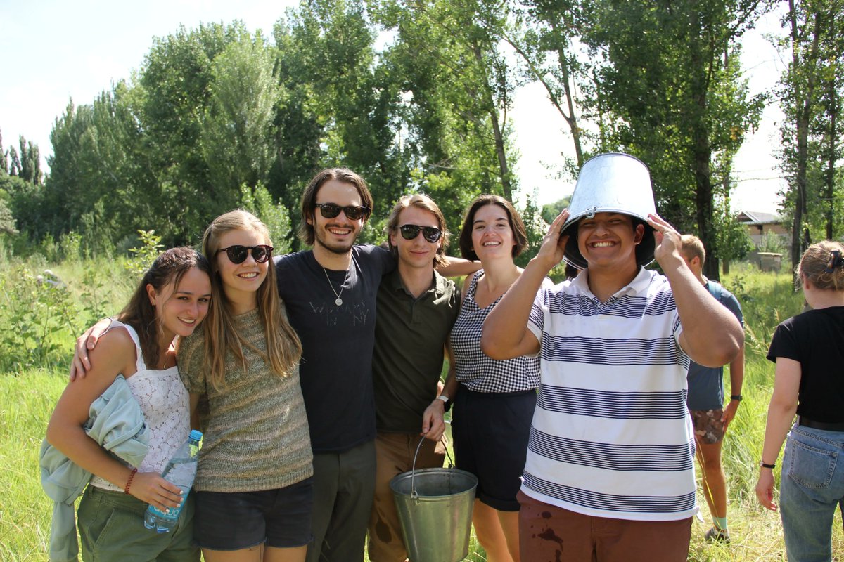 CLSscholarship's tweet photo. #CLSRussian students water saplings in a groove in Bishek, Kyrgzstan—a well-deserved break after a long day of intensive #criticalanguage study! Want to learn what it's like to be a CLS student? Read our latest student spotlight: https://t.co/uo6VJ5BoLX @ECAatState https://t.co/d3F7xs14so
