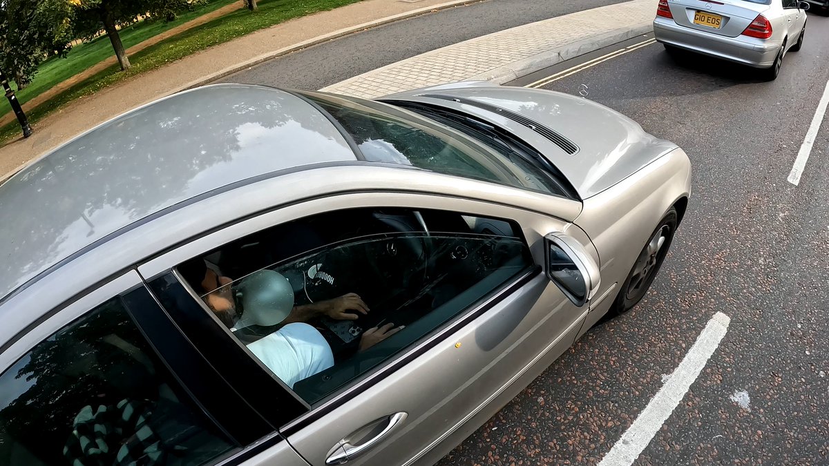 MikeyCycling's tweet photo. Today I saw a driver using his phone whilst huffing NO2 from a balloon. I feel, quite frankly, disturbed and upset by this. I did not know what to do, and don't think I got enough phone evidence to report. https://t.co/zroFR6mXvs