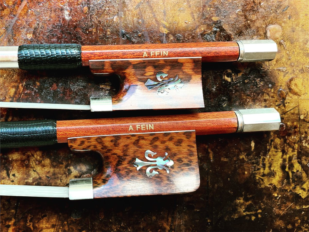 FeinViolins's tweet photo. New fancy-schmancy (that's a technical term!) violin & cello hybrid bows with abalone fleur-de-lis inlay. Carbon core with a #Pernambuco veneer. Predictability of a carbon bow with the warm tone of PernambucoCarbonViolinBow #CarbonCelloBow #ViolinBow #CelloBow. https://t.co/YXdxbNKQWb