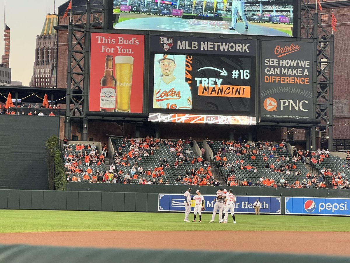 JuliaMorales's tweet photo. Trey Mancini hugs former teammates while a tribute video plays at Camden Yards. https://t.co/gL727bBaaE