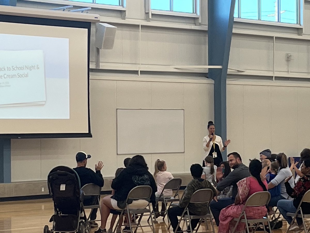 Principal Petrick at Back to School night accepting a donation from McDonalds and welcoming families with her teacher energy!