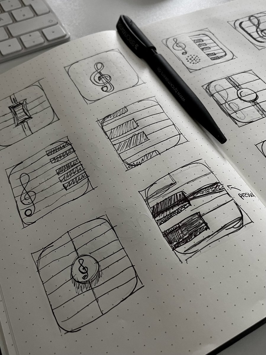 Several app icon sketches on paper