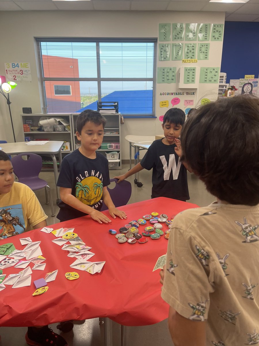 Our El Mercado Day has started!! Selling painted rocks and bookmarks that our students painted and made, pickles, Chamoy gummy bears, corn in a cup, nail salon, tattoos, and much much more!!#UESRooNation