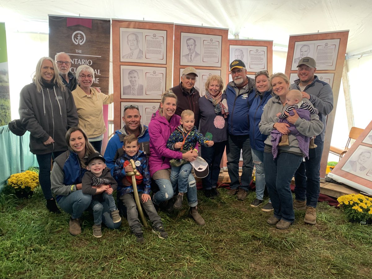 islandviewag's tweet photo. Was able to get some of the Bennett clan together for a pic at the @OttawaFarmShow display at @IPM2022. They featured the Eastern ON members of the @OntAgHallFame. My Dad is in the Hall of Fame. His pic is behind my niece in the purple coat. #proudmoment https://t.co/SOaHZTL5aI