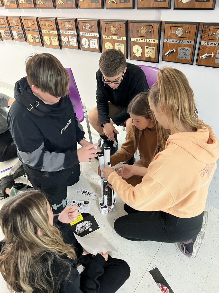 latrishaflax's tweet photo. This section of 8th graders is working within their economies to build a tower.  Traditional is struggling with the resource of time. Market is working together well. Mixed is frustrated by regulations and command’s dictator has his group working hard. @tregoeagles https://t.co/UEtJAEh0XG