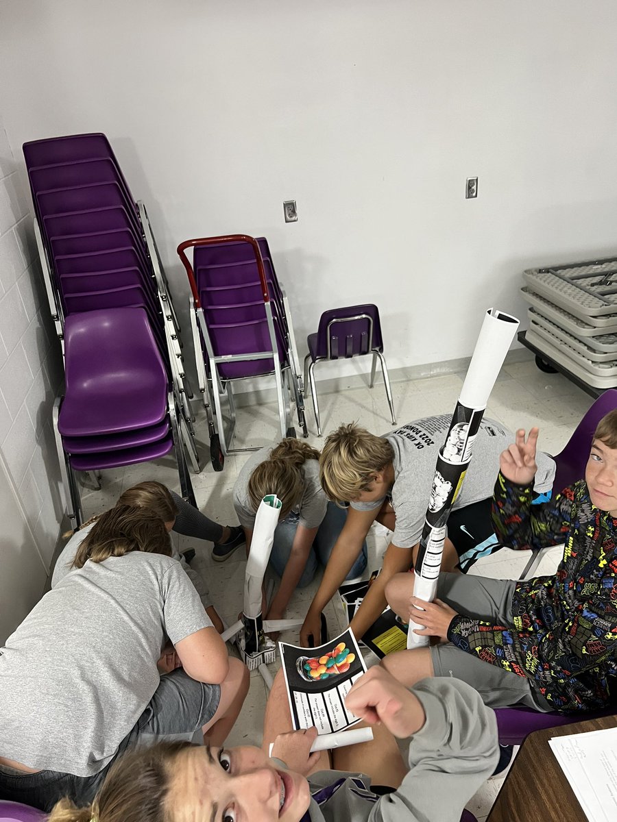 latrishaflax's tweet photo. This section of 8th graders is working within their economies to build a tower.  Traditional is struggling with the resource of time. Market is working together well. Mixed is frustrated by regulations and command’s dictator has his group working hard. @tregoeagles https://t.co/UEtJAEh0XG