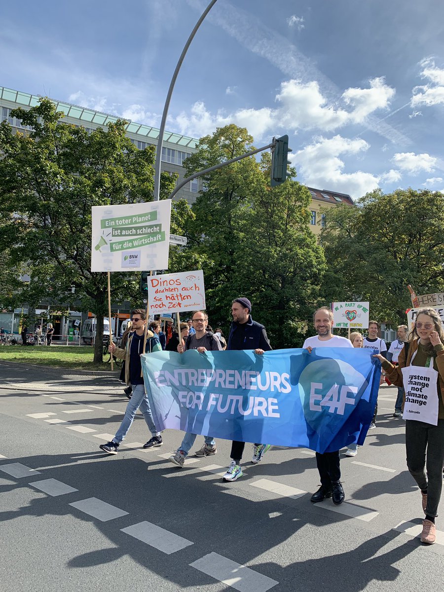 Picture of people striking on the street holding a large banner that reads “Entrepreneurs for Future”