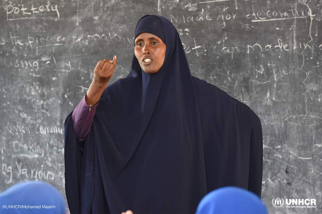 IbrahimGabow6's tweet photo. On International Day of #SignLanguages, we celebrate with Amina, a Somali refugee teacher and her students in Dadaab.
She has relied on sign language to communicate with refugee students living with hearing impairments for the last 9 years. https://t.co/6Ip0NGA8iA