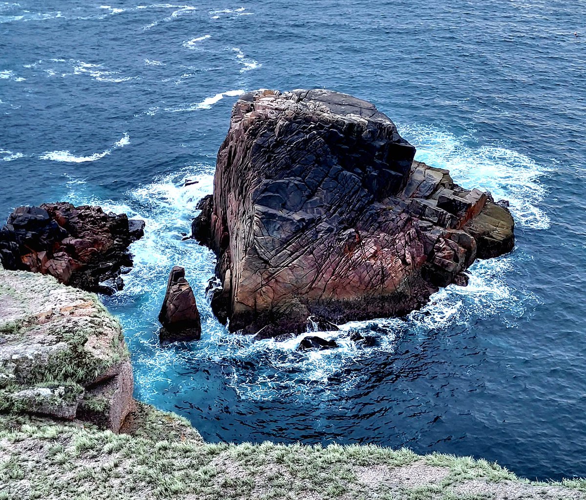 A Granite seastack at the back of Owey Island- giving off a pinkish glow in the late evening light. County Donegal, Ireland.