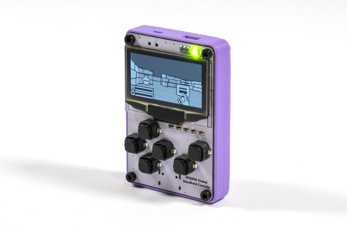 A small handheld console with an OLEd screen, dpad and 2 soft buttons. The whole thing is inside a 3d printed case, standing up. A 3D game is shown on the display.