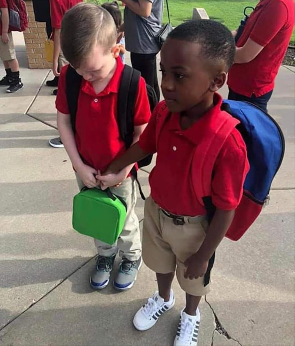 The boy with the green lunchbox is a child with special needs. He was so terrified to go to school he wept. The boy with the blue backpack comforted him by walking up & holding his hand. Kids will spread love if we don’t poison them with our prejudices. (How To Dad)