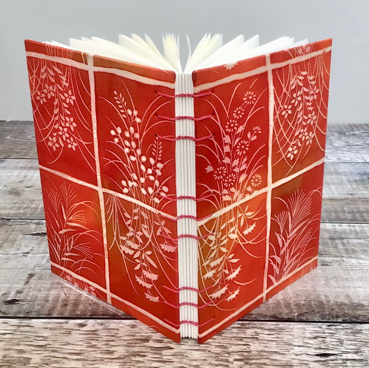BooksBySueDay's tweet photo. Upcycled kimono silk cover for this Coptic stitch journal, incorporating #RedPear and #TangerineTango #colour_collective https://t.co/5x948ilj1S