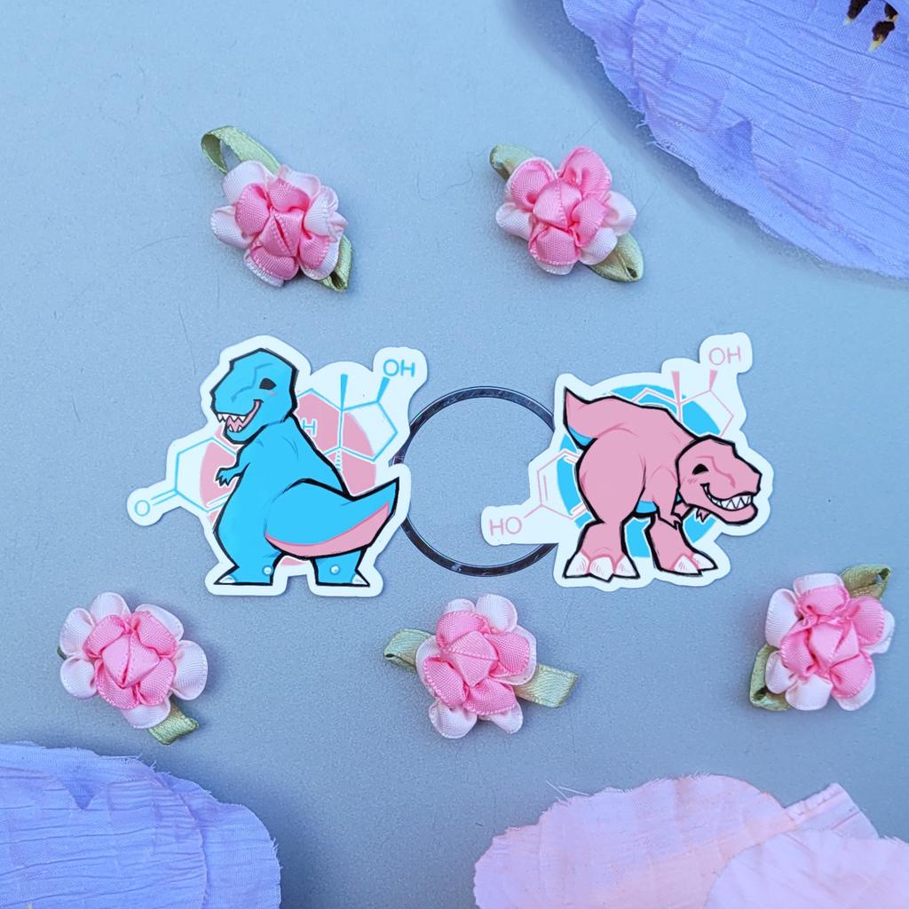 Katzunuwu's tweet image. HRT-Rexes. With the testosterone and estrogen molecules in the background. Stickers available to purch♡se in replies (RTs appreciated!)
