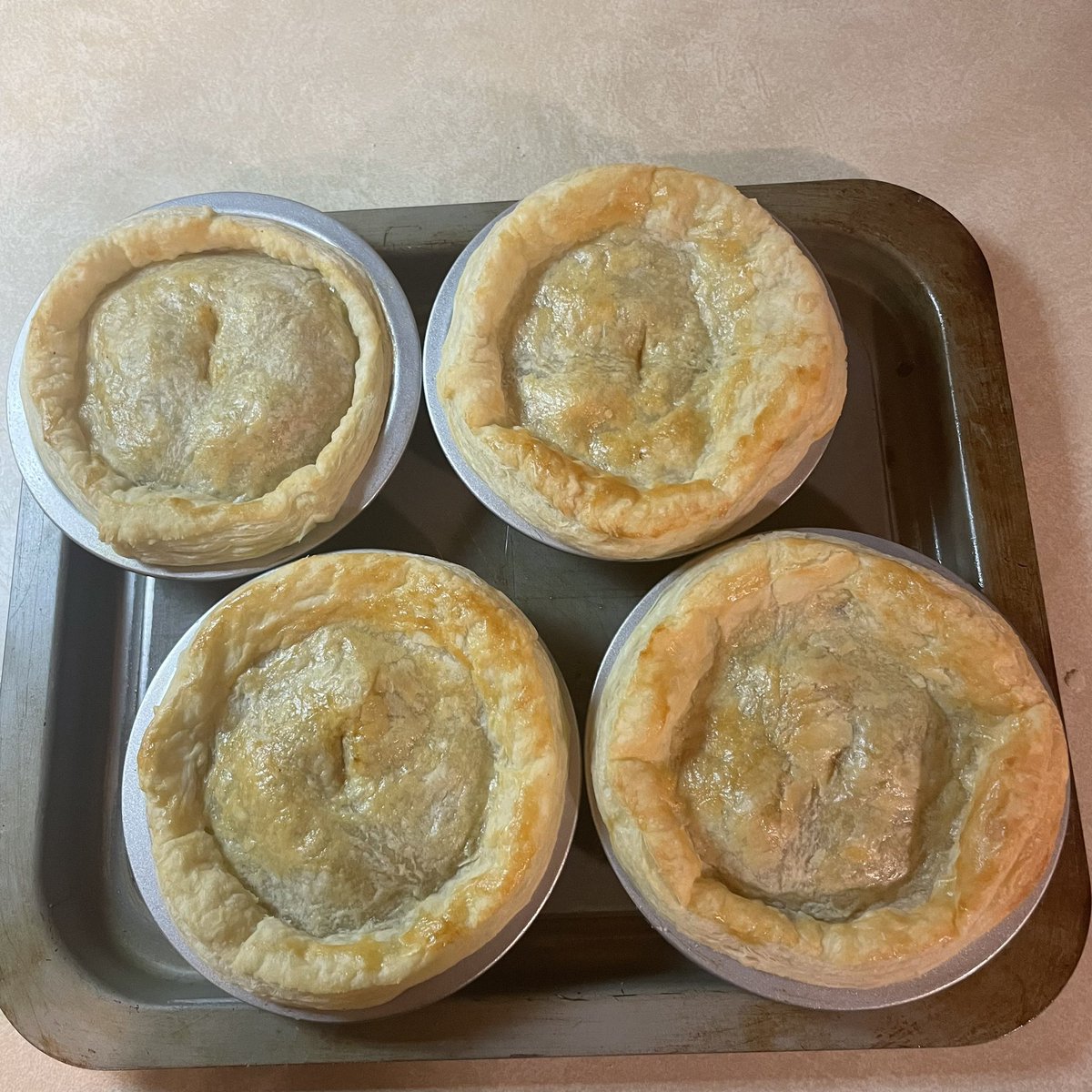 CoachHess40's tweet photo. Pie update!!! The pies are done and will cool till just before the stream! They look pretty good if I do say so myself! #Aussiemeatpie #AFLGrandFinal https://t.co/hLkTzZzoDJ