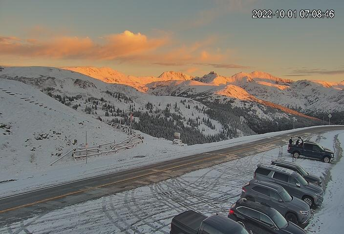 This Loveland Pass webcam (at ~12,000 ft) reveals a fresh blanket of snow at the higher elevations, as the rising sun illuminates the higher peaks (Hagar Mtn, Pettingell Peak in the background). #COwx