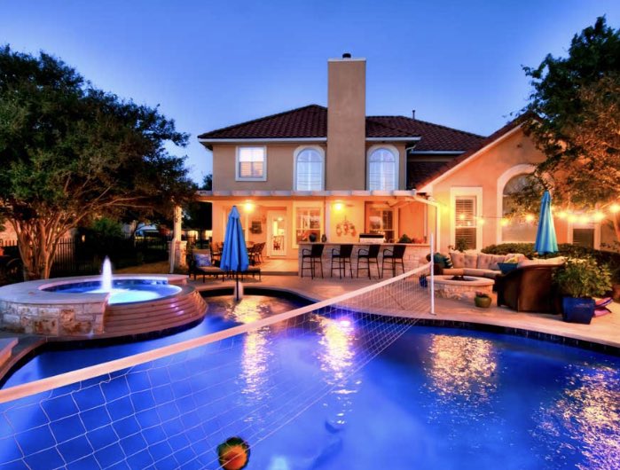 Add an element of fun to your custom pool with a volleyball net. #AustinPoolBuilders #AustinSwimmingPools #ReliantPools