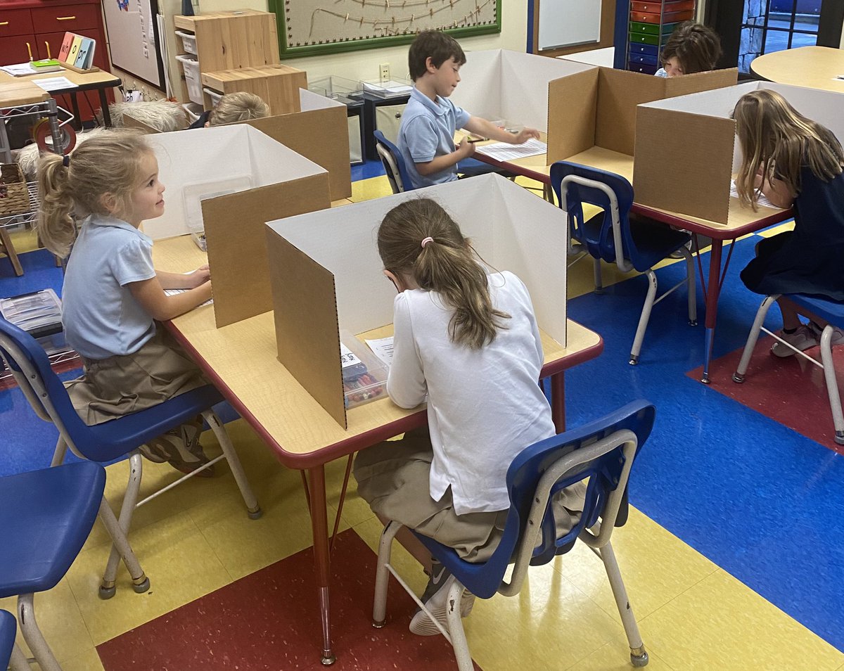 A typical day “at the office.” K s’s loved using privacy folders (their offices) for dictation this week! #trinitylearns