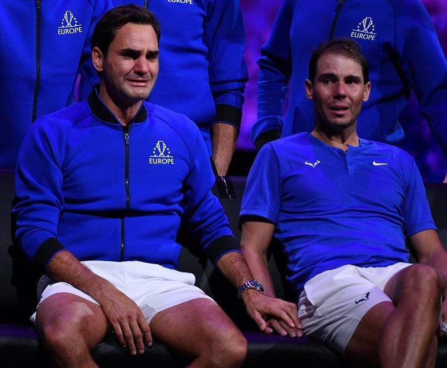 6thrat's tweet photo. Roger Federer and Rafa Nadal ugly crying while holding hands together at Federer's farewell, is the single most defining image and memory I can think of that may help recast what "masculinity" is. Men cry. They hold hands. They show feelings. There's nothing "unmanly" about it ❤️ https://t.co/9oA9k1CxNJ