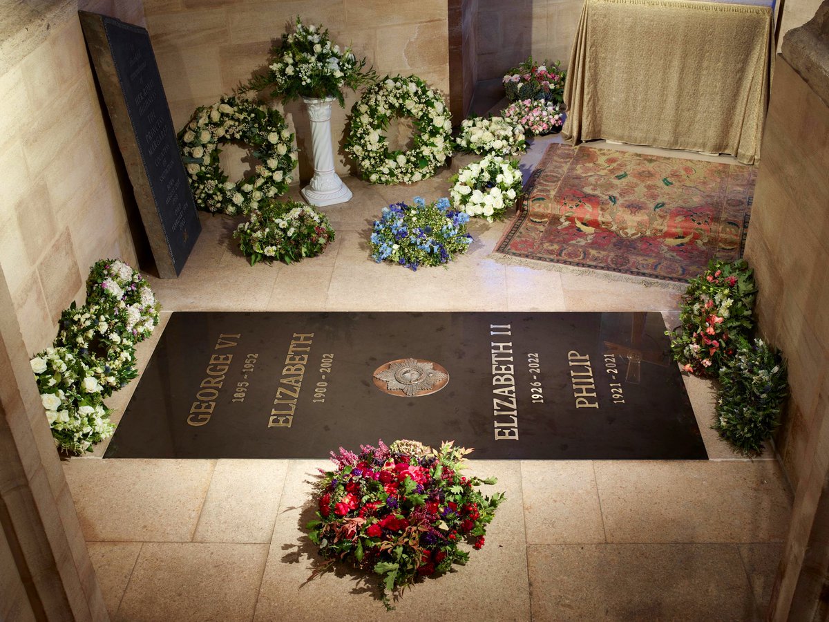 Here is the first official picture of the Queen’s final resting place. 
Buried with her husband, Philip and her parents. 
The ledger stone in the George VI Memorial Chapel now reads:
George VI 1895-1952
Elizabeth 1900-2002
*Garter star*
Elizabeth II 1926 - 2022
Philip 1921-2021