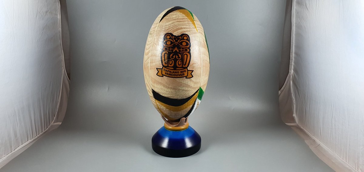It seemed like about time to make the stand I always had in mind for the rugby ball I turned a couple of years ago. The idea was fit to look like a kicking tee holding the ball. It is from the same dogwood the ball was made from and airbrushed with colours from the team logos.