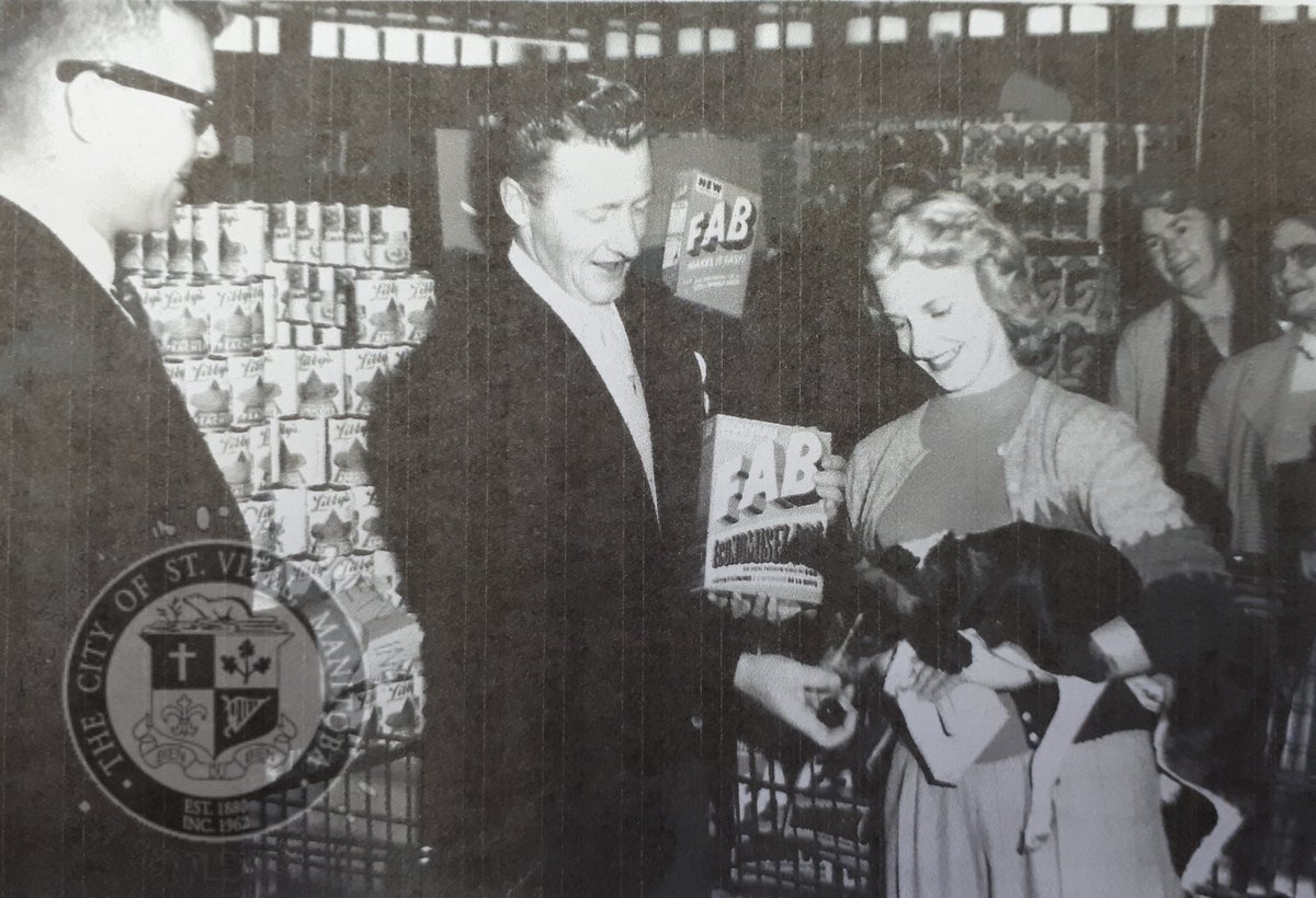 “Red” Alix of CJOB's "Wake Up Winnipeg" with Patsy Davies and her dog Snookie (63 Hull Ave, St. Vital) at the Shop-Easy next to the Windsor Theatre, 1956. Patsy ran a dog grooming business called "Pat's Poodle Parlor." #stvitalmuseum #stvital #museum #archives #winnipeg #manitoba