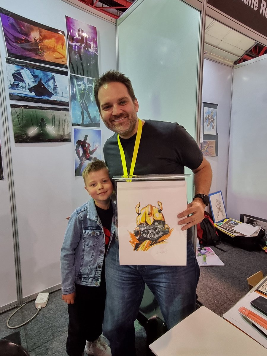 JarrodPottow's tweet photo. @LivioRamondelli @ComicConAfrica Thank you @LivioRamondelli we are overjoyed with our Bumblebee drawing. What a privilege to meet you in person as well. https://t.co/1EM3FPAaaK