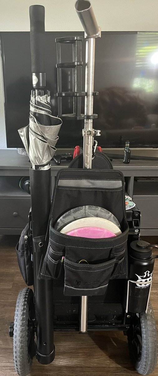 JonnyP93304's tweet photo. Made an umbrella holder for my @zucainc cart. Had a bottle holder break so thought I would make good use of the space. Drilled a couple holes painted the whole thing black and bang upgrade. #discgolf #zuca #dglife #customwork #DIY https://t.co/Z9xXWq3KbQ