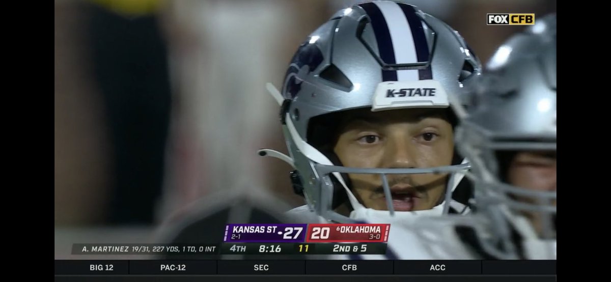 MIATCShow's tweet photo. Hey @UniWatch, we’ve got KState’s Martinez wearing a helmet with no bars on the top of the face mask at all, we don’t see this often yeah? https://t.co/rhZjSNw89b