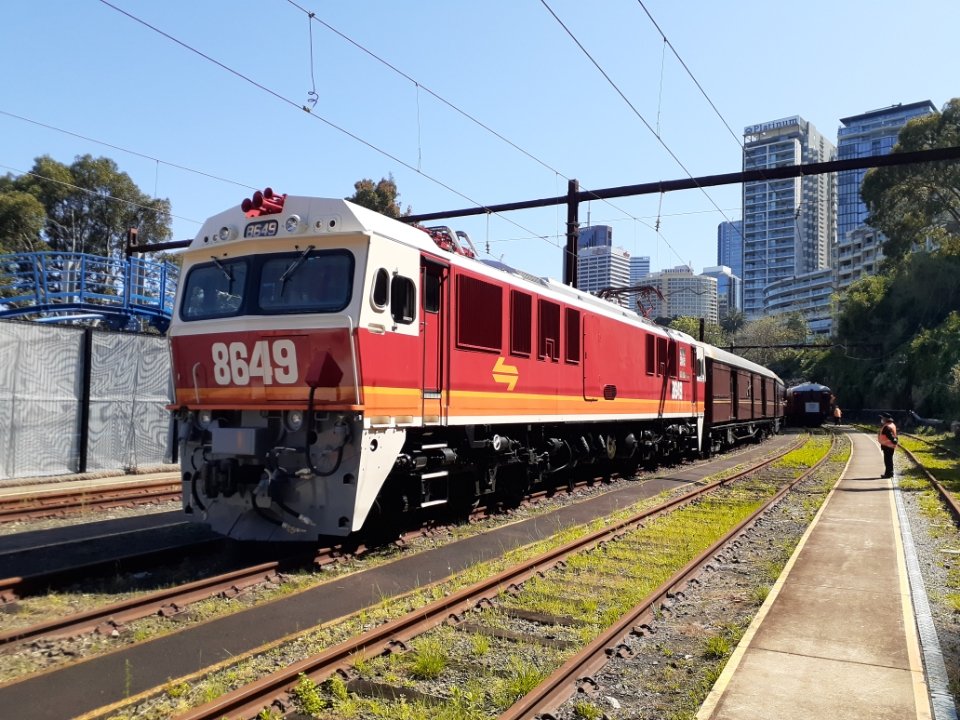 This morning, our electric locomotive 8649 assisted steam locomotive 3801 through the City Underground and across the Sydney Harbour Bridge!

Here we see 8649 basking in the morning sun down at Lavender Bay after leading the train down from Waverton.