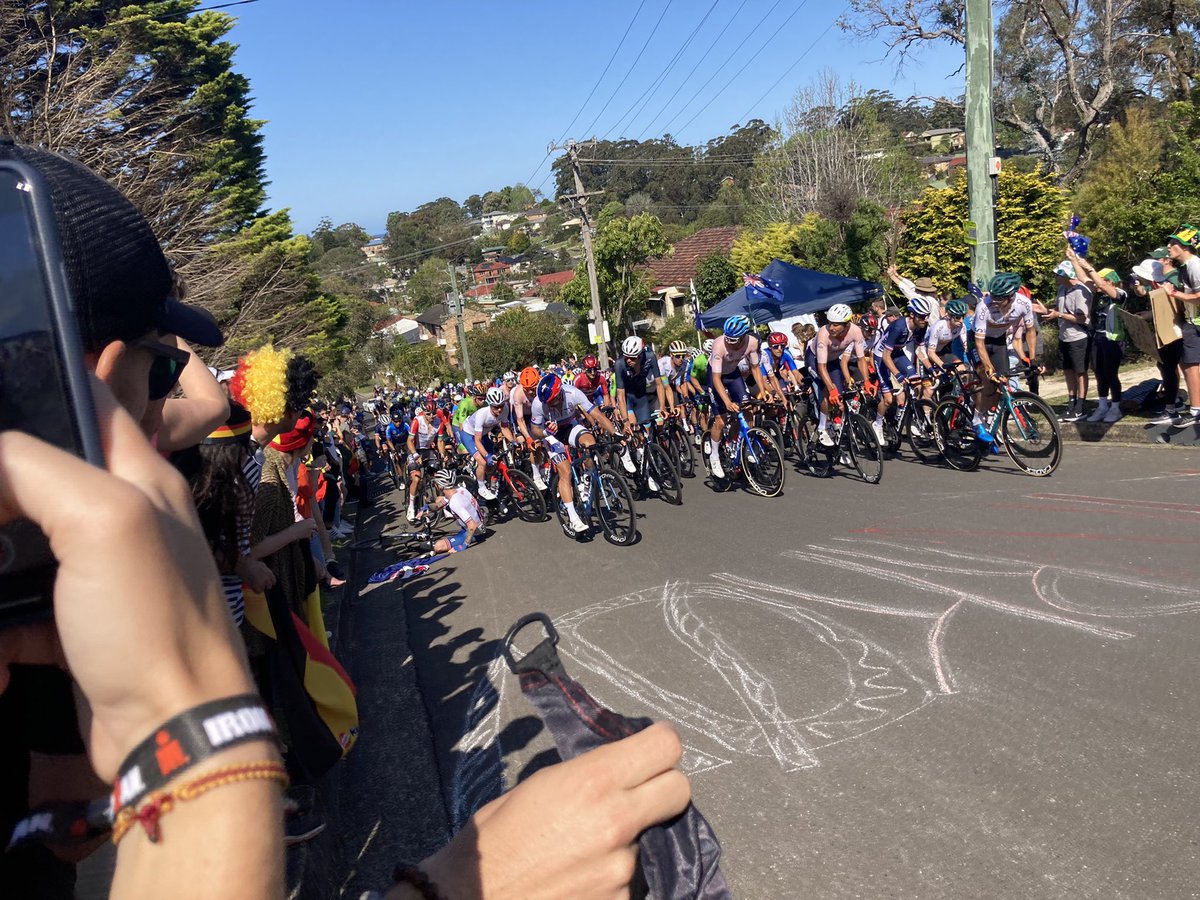 thatbikenerd's tweet photo. Jake Stewart falls on Ramah Ave after clipping a fan’s Aussie flag. Not a happy boy #Wollongong2022 https://t.co/aGwo4GPQ4l