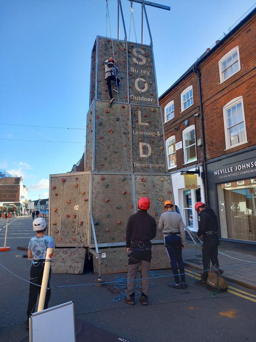 GuildfordBC's tweet photo. Fun in the sun at #carfreeday #Guildford today. Come and have a go on the FREE 9 metre climbing tower on the Upper High Street. Brought to you by Surrey Outdoor Learning and Development https://t.co/pxYv4a97K9