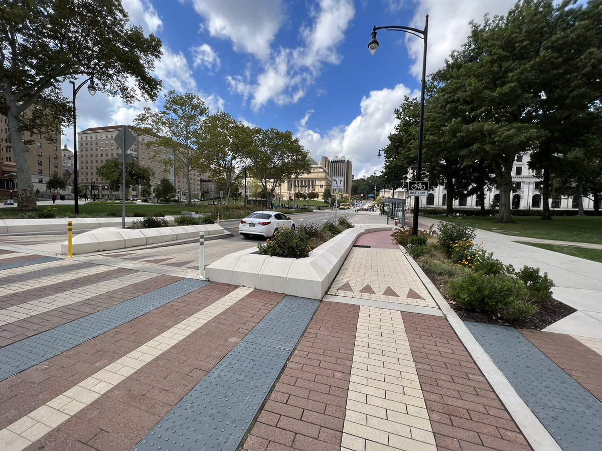 Streetfilms's tweet photo. Despite dreary prediction of rain &amp; thunderstorms it ended up being a gem in @BikePGH Rode @pogohbikes e-bike for ~4 hours.

Saw much including this new, amazing one long block street at Pitt.

-raised x-walk
-bioswales
-protected bike lane
-traffic calming &amp; more
-bus shelters https://t.co/a96aTLE9fy