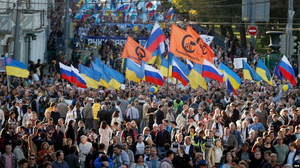 2014 marches for peace in central Moscow, tens of thousands of people came. In the first pic is one of the organisers, Boris Nemtsov, and the sign says "Hands off Ukraine". 

He was planning to lead another anti-war rally in March 2015, but was shot dead a couple of days before.