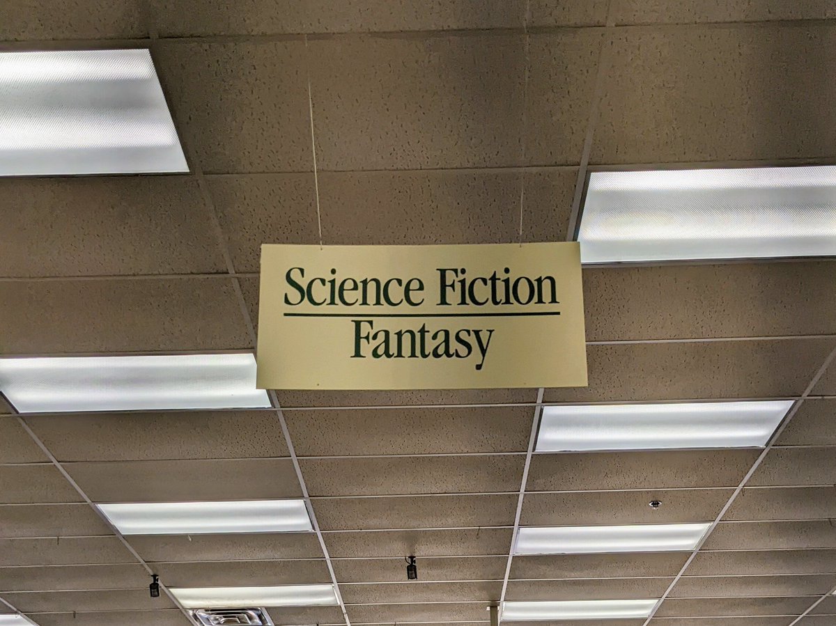 rescuethecows's tweet photo. Just to clarify: science fiction is at the top of the sign, fantasy is at the bottom. https://t.co/BfzWislP28