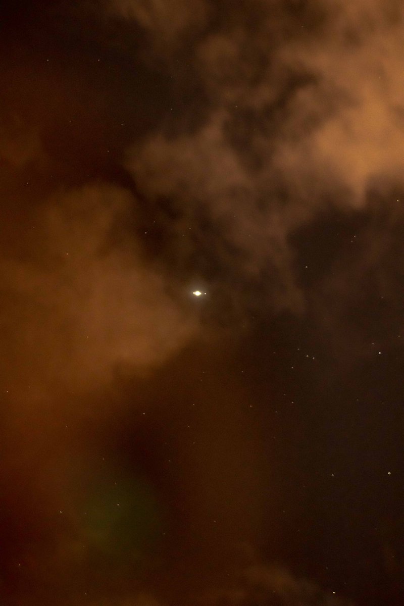 Jupiter so bright, its peering right through the clouds! You can even see three of the Galilean moons !