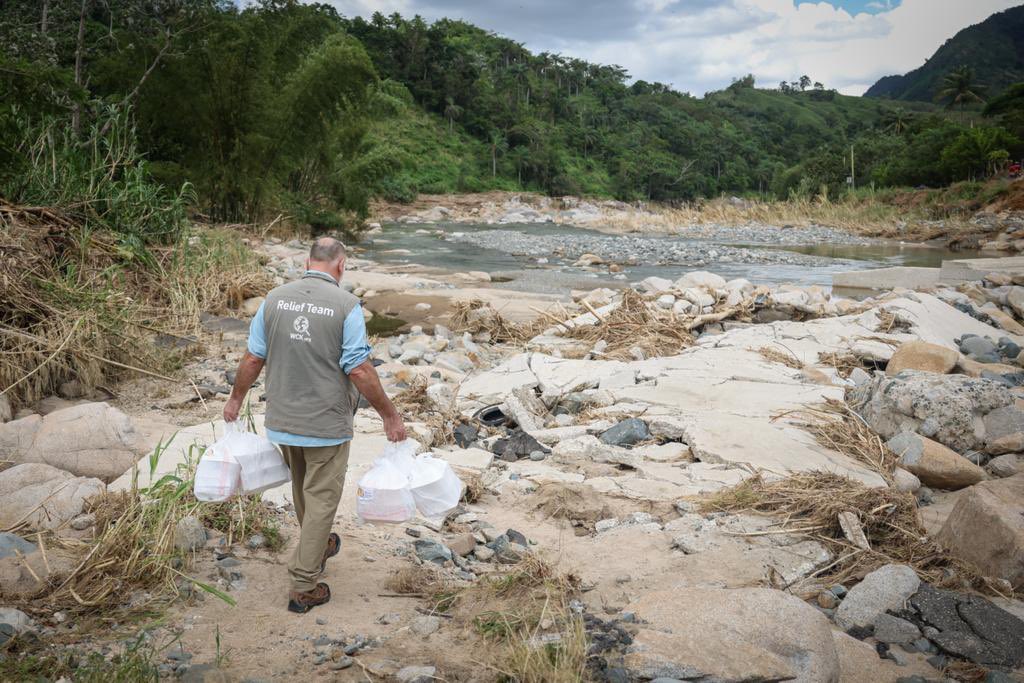 WCKitchen's tweet photo. About 30 families in a community in Utuado, Puerto Rico have been cut off from neighboring towns due to a bridge destroyed in the hurricane. To ensure they have fresh, hot meals, the WCK team crosses the river when it’s low enough to safely deliver! #ChefsForPuertoRico https://t.co/5L5X8FNHV2