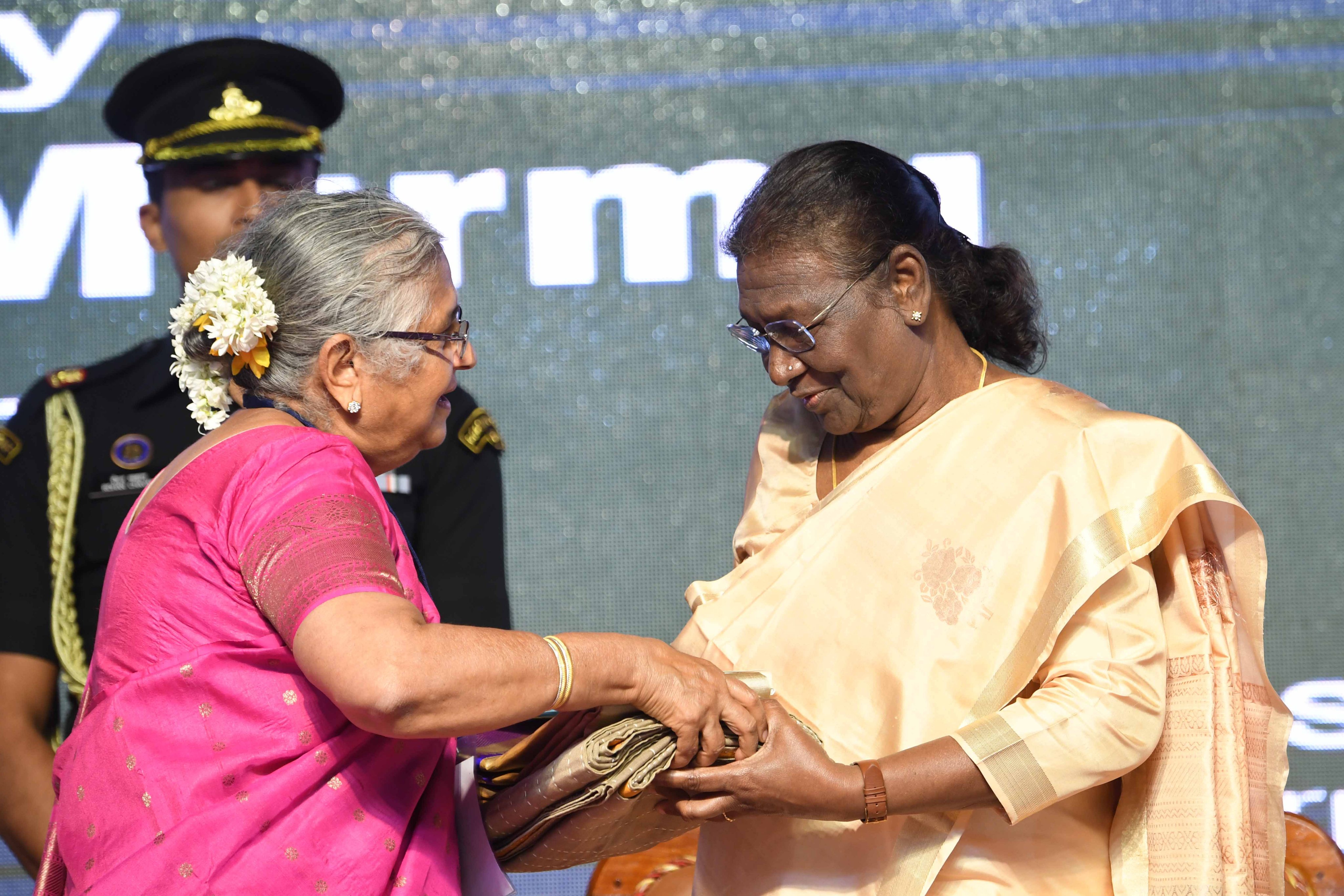 Chairperson of the Infosys Foundation Sudha Murthy presenting Irkal sarees to President Draupadi Murmu