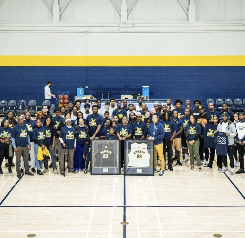 HumberHawksMBB's tweet photo. On Saturday we hosted our annual alumni game. This year, we payed tribute to one of the best to ever wear the Navy and Gold, Kenny Ejim. Before the alumni escaped with a 107-106 OT win, Ryan Ejim shared a story of growth that resonated with those in attendance. #LLKE #22forever https://t.co/4KhtDqiHGN