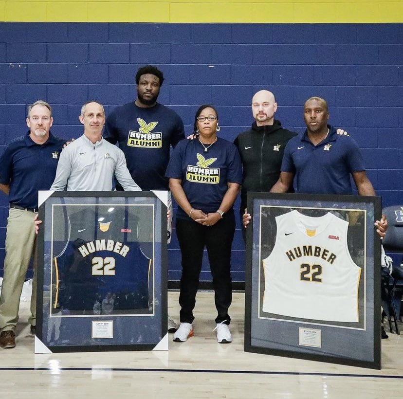 HumberHawksMBB's tweet photo. On Saturday we hosted our annual alumni game. This year, we payed tribute to one of the best to ever wear the Navy and Gold, Kenny Ejim. Before the alumni escaped with a 107-106 OT win, Ryan Ejim shared a story of growth that resonated with those in attendance. #LLKE #22forever https://t.co/4KhtDqiHGN
