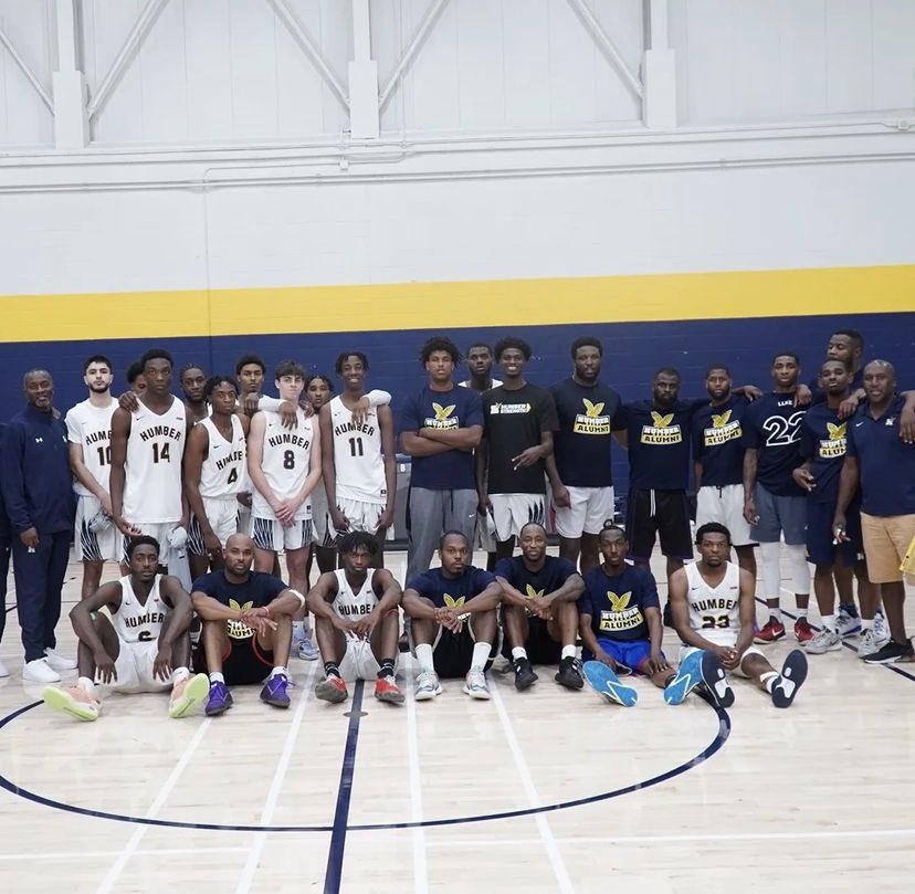 HumberHawksMBB's tweet photo. On Saturday we hosted our annual alumni game. This year, we payed tribute to one of the best to ever wear the Navy and Gold, Kenny Ejim. Before the alumni escaped with a 107-106 OT win, Ryan Ejim shared a story of growth that resonated with those in attendance. #LLKE #22forever https://t.co/4KhtDqiHGN