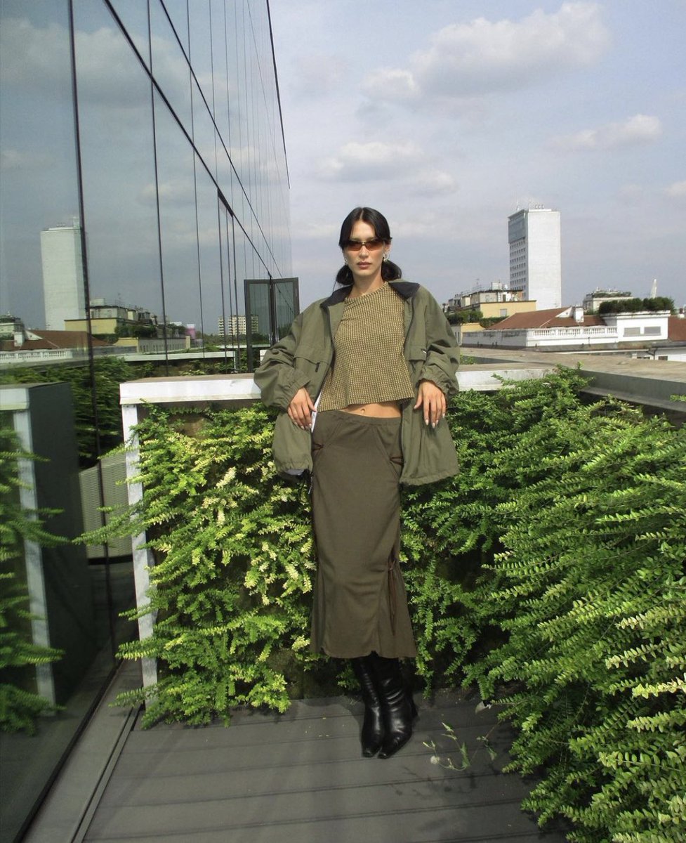 bella hadid wearing issey miyake leather boots & lace-up skirt