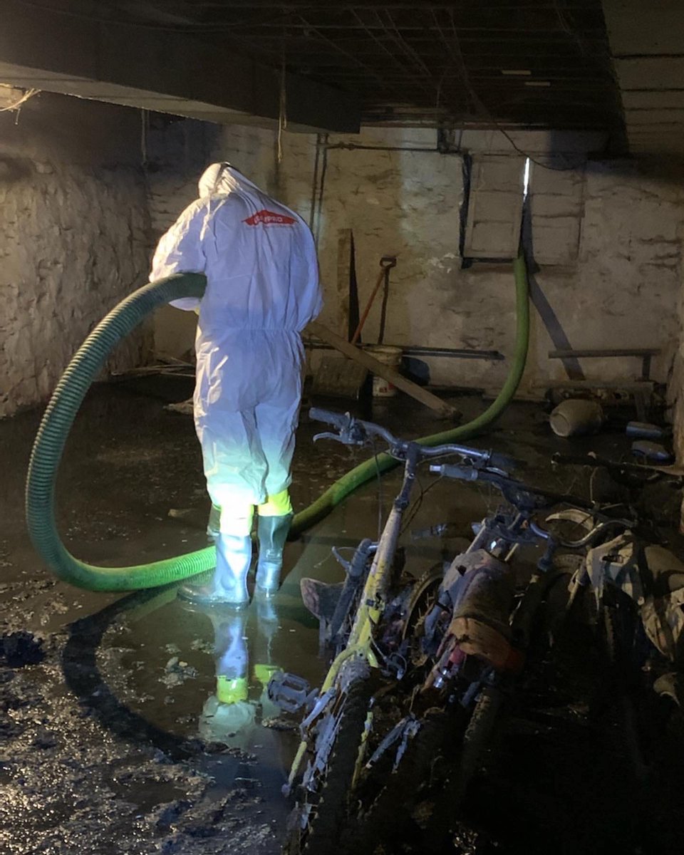 Some jobs can get a little messy! Here you can see one of our technicians suited up in full PPE, cleaning a basement affected by a sewage backup.